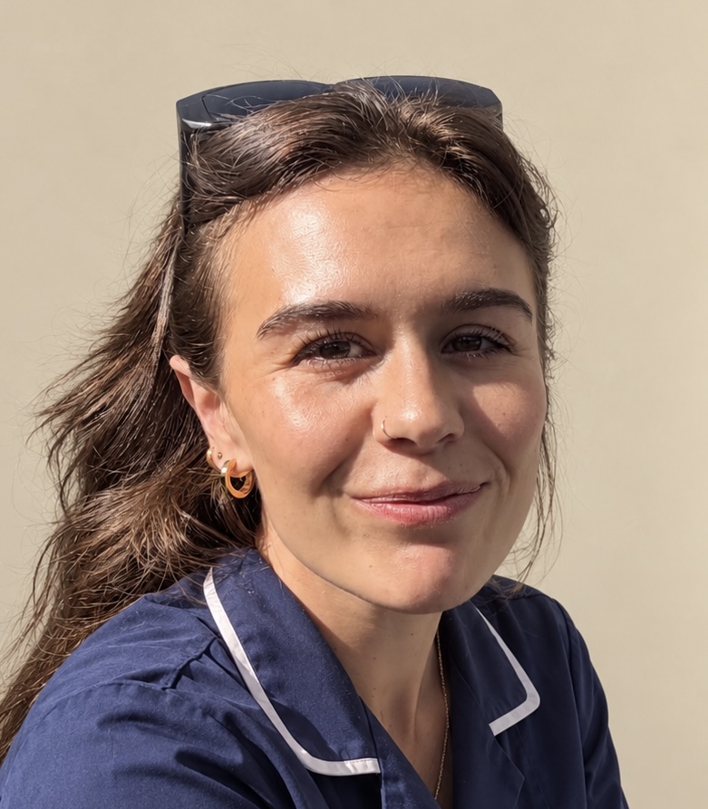 Kayleigh smiling in a navy midwife tunic